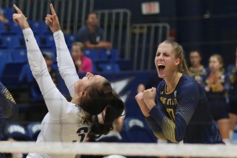 Kent State seniors Challen Geraghty (left) and Kelsey Bittinger celebrate after scoring a point during the first match against Akron Friday, Sept. 22, 2017.