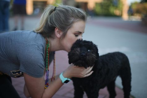 Kitty Kristindottir kisses her dog, Percy, during the annual Kiss on the K on Risman Plaza.