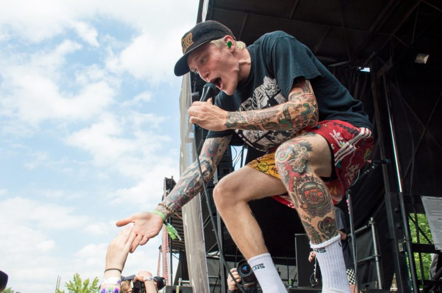 Ben Barlow, singer for Neck Deep, high fives a fan who crowd surfed her way to the stage during their performance on the Cuyahoga Falls date of the Vans Warped Tour on Tuesday, July 18, 2017.
