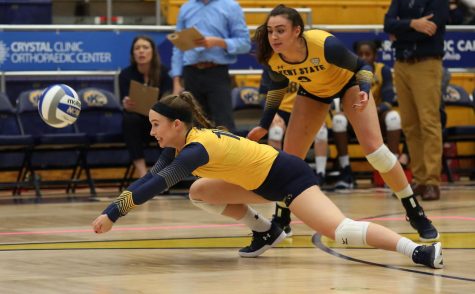 Kent State sophomore Claire Tulisiak dives for the ball while junior Lexi Mantas watches during the Homecoming match Oct. 14, 2017.