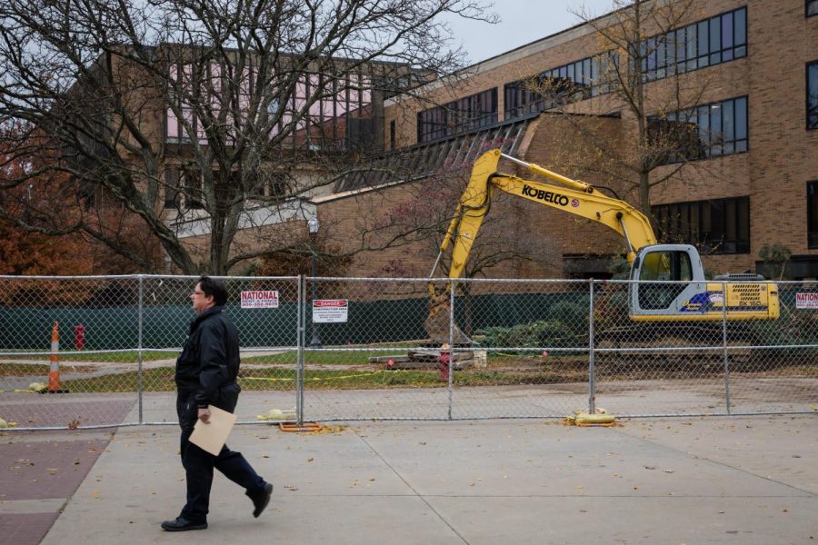 A man walks past construction outside the Business Administration Building Wednesday, Nov. 15, 2017. A new Starbucks will open on the Esplanade for the spring semester. 