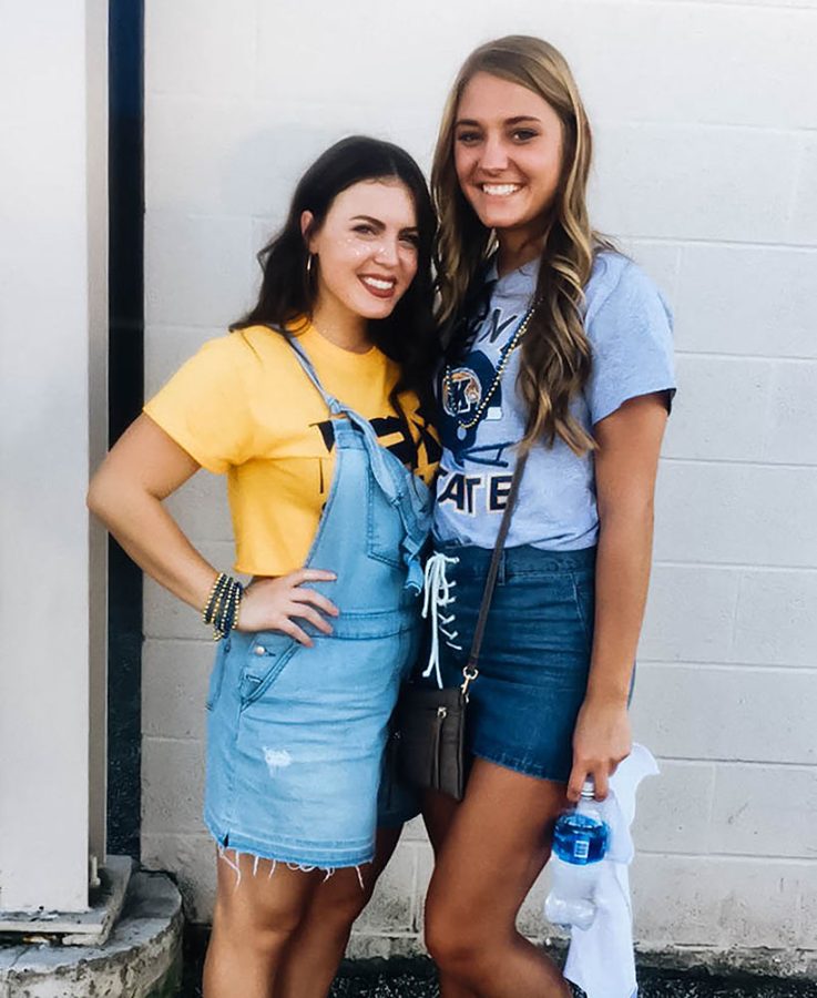 Jenna Evan (right), a junior early childhood education major, and Jaime Sammons, a sophomore integrated langauge arts major, pose for a picture before Kent State’s Homecoming football game Oct. 14.