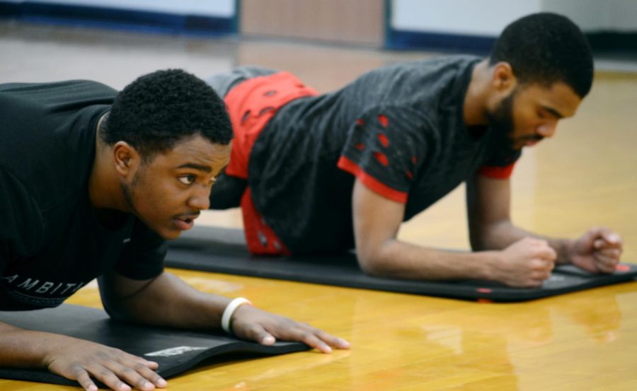 Freshman construction management major Jason Booker and freshman digital media production major Peter Lindo concentrate as they do their planks Saturday, Dec. 2, 2017, an activity part of the Big Brothas Program.