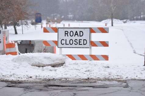 Road closed signs sit in snow on the old West Campus Center drive Monday Jan. 15, 2018. The change of West Campus Center is part of the current Summit Street project.