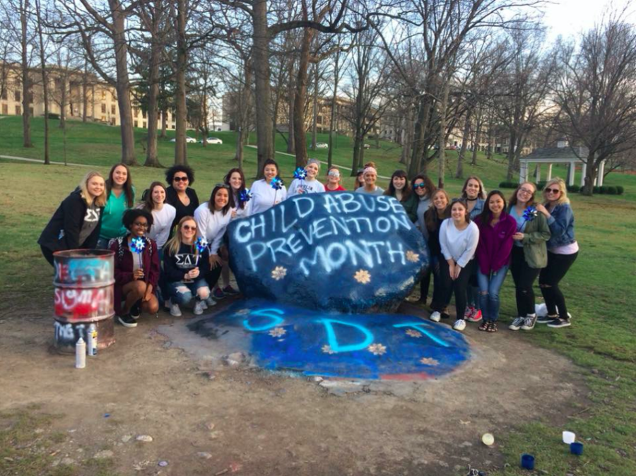 Members of Sigma Delta Tau gather around the Rock on Kents campus