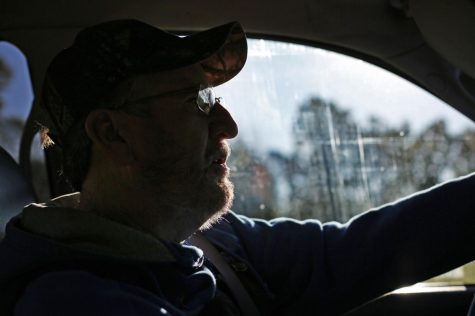 John Bowman drives on a early morning to the location of his tractors to begin logging for the day.