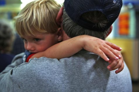 John Bowmans 8-year-old grandson, Caidean, hugs him while waiting in a line at a Walmart Pharmacy in Rowan County.