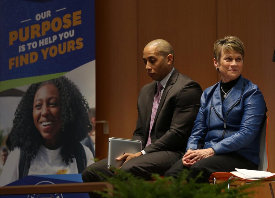 Firestone High School Principal Larry Johnson and President Beverly Warren listen to David James, the superintendent of Akron Public Schools, speak at a press conference Wednesday, Feb. 21, 2018, which announced a partnership geared toward experiential learning. 