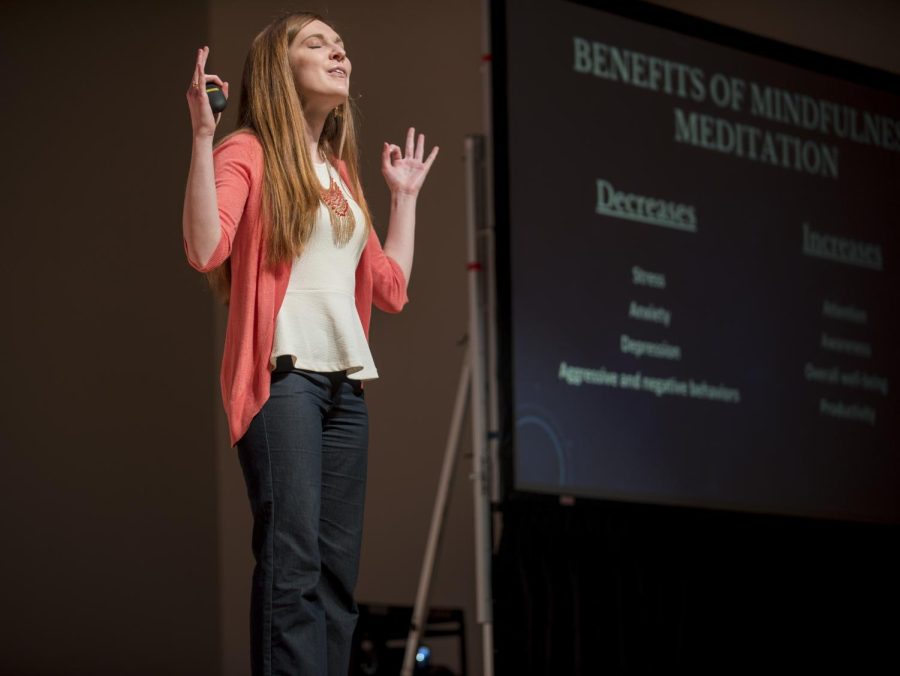 TedxKentState+speaker+Jessic+Koltik+does+a+quick+demonstration+of+traditional+medittion+during+her+talk+on+mindfulness+meditation+Friday+morning%2C+Feb+23%2C+2018.+This+year%E2%80%99s+TedxKentState+theme+was+Pale+Blue+Dot.