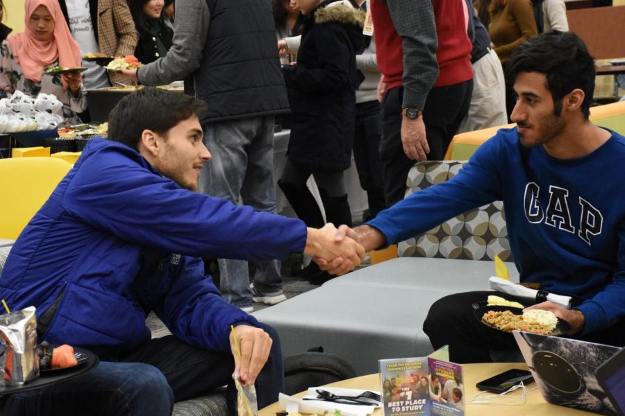 Students greet each other at international student reception.
