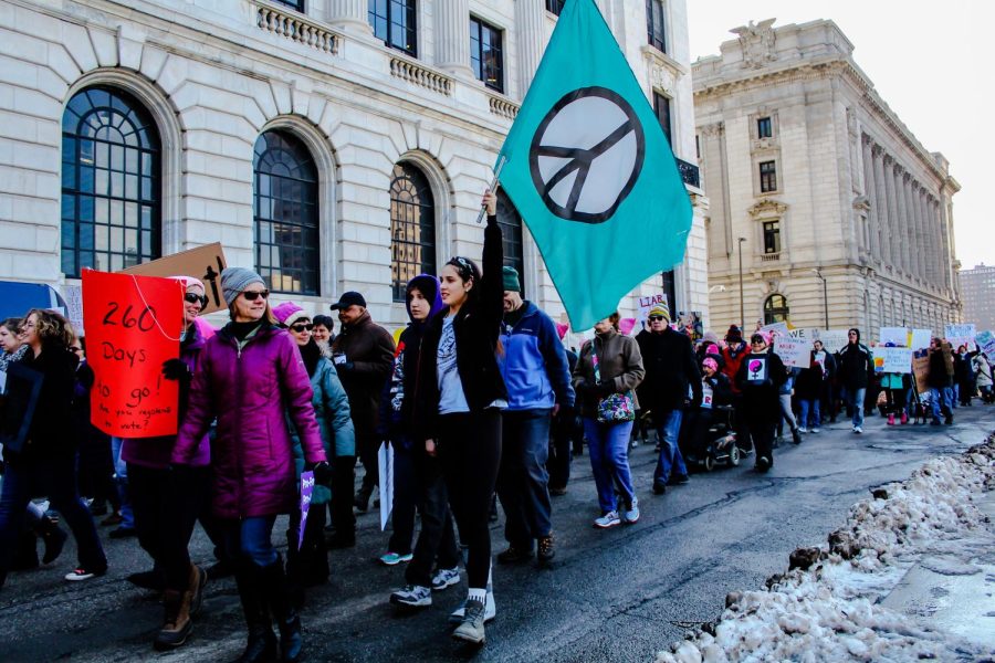 The+crowd+marches+through+the+streets+of+Cleveland+as+they+lift+flags+and+signs+during+the+Womens+March+Jan.+20%2C+2018.