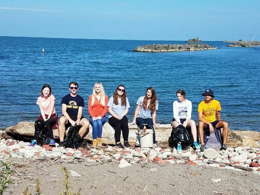 Members of Ocean Motion pick up trash on the beach. 