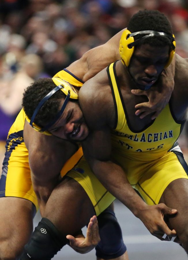 Kent State's Kyle Conel grapples with Appalachian State's Randall Diabe during day one of the NCAA Wrestling Championships at Quicken Loans Arena. Conel won all three of his matches on the day. 