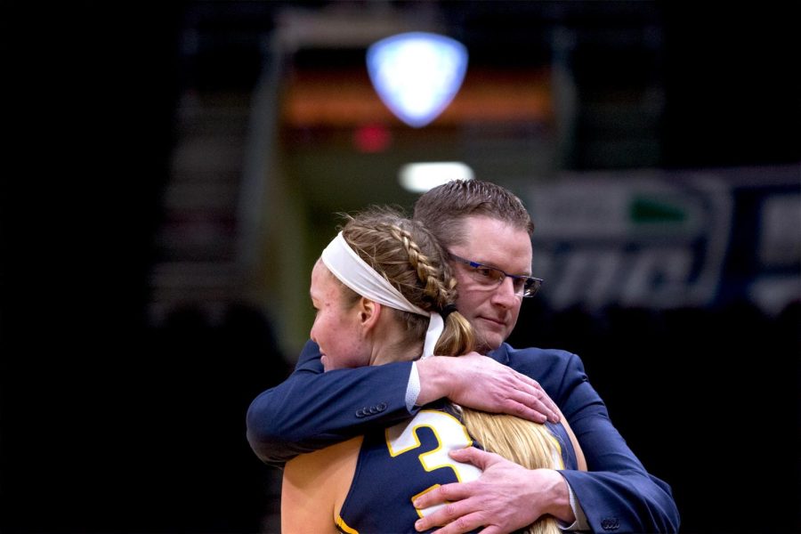 Kent State senior forward Jordan Korinek and coach Todd Starkey share an embrace after being subbed out of the Flashes 72-50 loss against Buffalo in the MAC Tournament March 7, 2018.