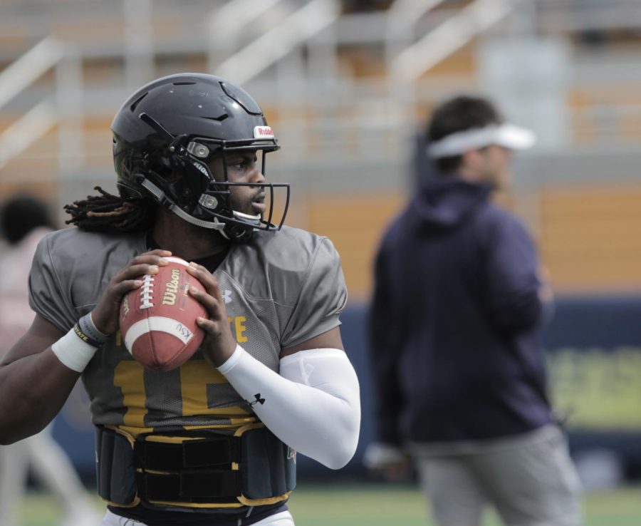 Flashes quarterback Woody Barrett drops back for a pass during a drill before Kent State's spring game on April 14, 2018. Barrett is entrenched in a three-way quarterback battle heading into the team's season opener at Illinois. 