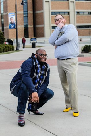 Despite the low turnout, Aaron Brown (left) and Sven Rundman (right) show off their heels during the Walk a Mile in Their Shoes event on Tuesday evening.