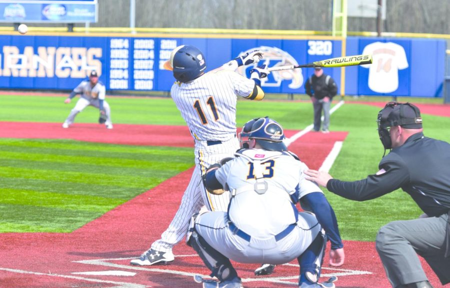 Senior Mason Mamarella swings at a pitch against Canisius on April 11, 2018. The Flashes held off a furious ninth-inning comeback from the Griffins to win, 13-11. [FILE]