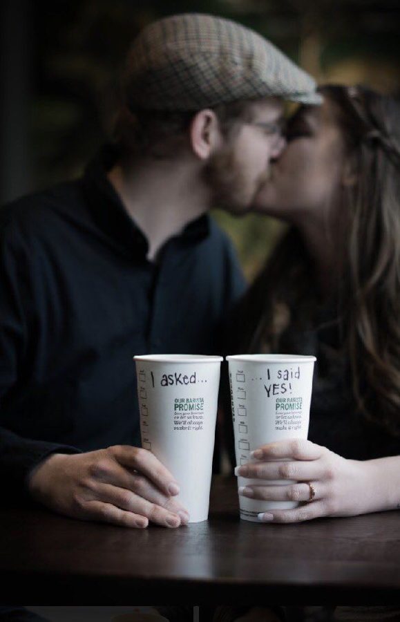 The couple poses for a photo with their Starbucks drinks.