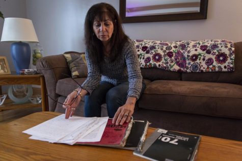 Anna Zsinko, 59, of Streetsboro, leafs through her late son’s journals Wednesday. Matt wrote since about high school, and in the last six months, revealed what it was like to be a heroin addict.