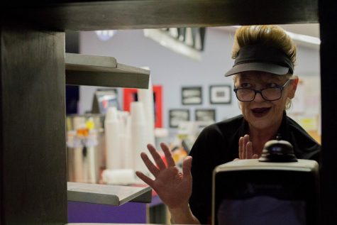 (10:41pm) Dona talks to the bartender through the window to the kitchen at Twin Star Lanes in Kent, Friday night, April 20, 2018. Dona used to work for the Kent School district until they let go of part time employees. They said just a few hours a week and thats about all I wanted. That was four years ago, Dona said. Zack Davis/The Kent Stater