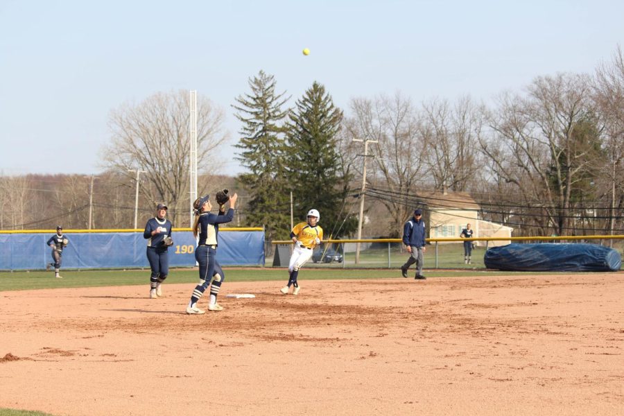 Kent State junior Sydney Anderson rounds the bases as Pitt shortstop Olivia Gray catches a fly ball during the Flashes 6-4 loss on April 18, 2018.