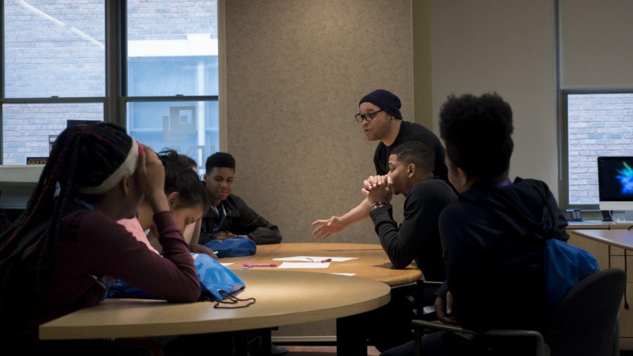 Jamil Wright, a rising 10th grader at Akron’s NIHF STEM High School, works with other I Promise students on their team brand identity on June 18 at Kent State University.