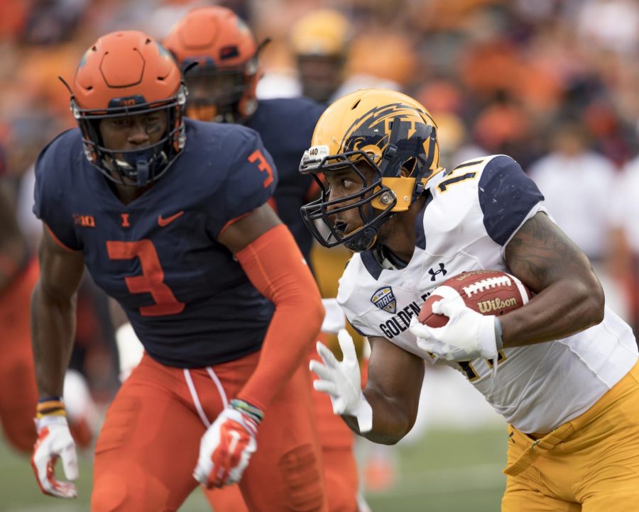 Kent State running back Justin Rankin rushes past Illinois DelShawn Phillips in the second half of their game against Illinois at Memorial Stadium on Sept. 1, 2018. The Flashes lost to Illinois 31-24.