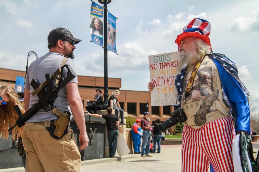 Greg Fisher from Kent, OH. argues with a demonstrator during the open carry demonstration on Friday, April 27.
