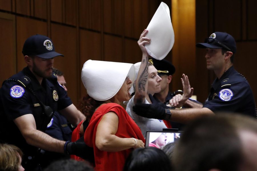 Protesters of President Donald Trumps Supreme Court nominee, Brett Kavanaugh, protest while wearing costumes from the show The Handmaids Tale, during his confirmation hearing with the Senate Judiciary Committee on Capitol Hill in Washington, Wednesday, Sept. 5, 2018, during the second day of the confirmation hearing to replace retired Justice Anthony Kennedy. (AP Photo/Jacquelyn Martin)