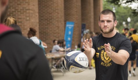 Tyler Williams, junior aerospace engineering major, passes a ball to a student interested in joining the Kent state Men’s Rugby Club during the Black Squirrel Fest.