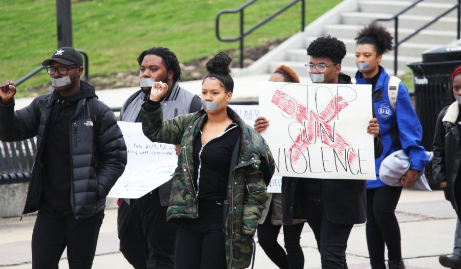 Black United Students walk in solidarity and silence as they protest against the gun violence in the country.