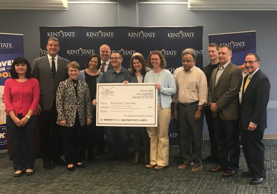 President Beverly Warren and Congressman Tim Ryan present check to faculty researchers on Monday, Sept. 10, 2018. 