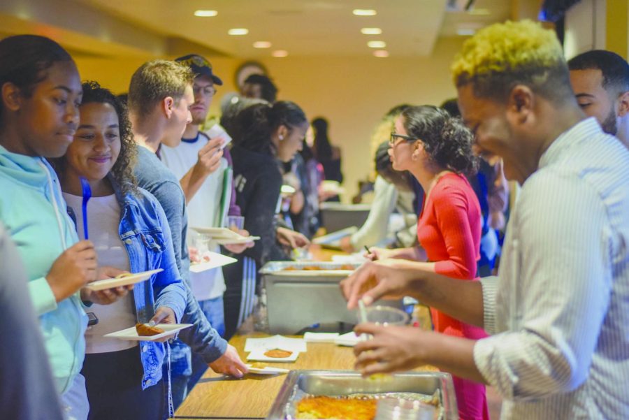 Students recieve samples of different foods at the Cultural Celebration Cook-off in the Student Center Ballroom Balcony on Tuesday, Sept. 11, 2018.  