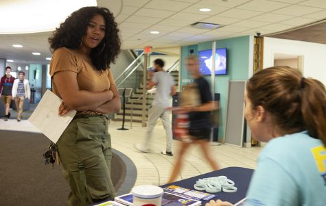 Junior business management major Hannah Robinson (left) talks with junior marketing major Kelly Corey (bottom right) about the new meal plans in front of Rosie’s Diner in Tri-Towers on Friday, Aug. 24, 2018.