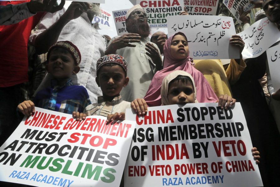Indian Muslims participate in a protest against the Chinese government, in Mumbai, India, Friday, Sept. 14, 2018. Nearly 150 Indian Muslims held a street protest in Mumbai, Indias financial capital, demanding that China stop detaining thousands of members of minority Uighur Muslim ethnic group in detention and political indoctrination centers in Xinjiang region. Placard reads Chinese government must stop atrocities on Muslims. (AP Photo/Rajanish Kakade)