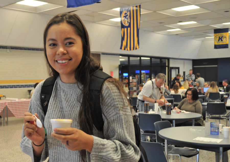 A student taste testing a cup of chili at Kent Tuscarwas chili cookoff to celebrate Kents 100 years of Homecoming. 