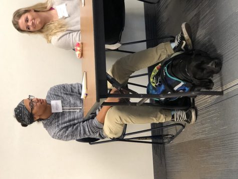 Mack and her service dog Merlin listen to questions from the audience.