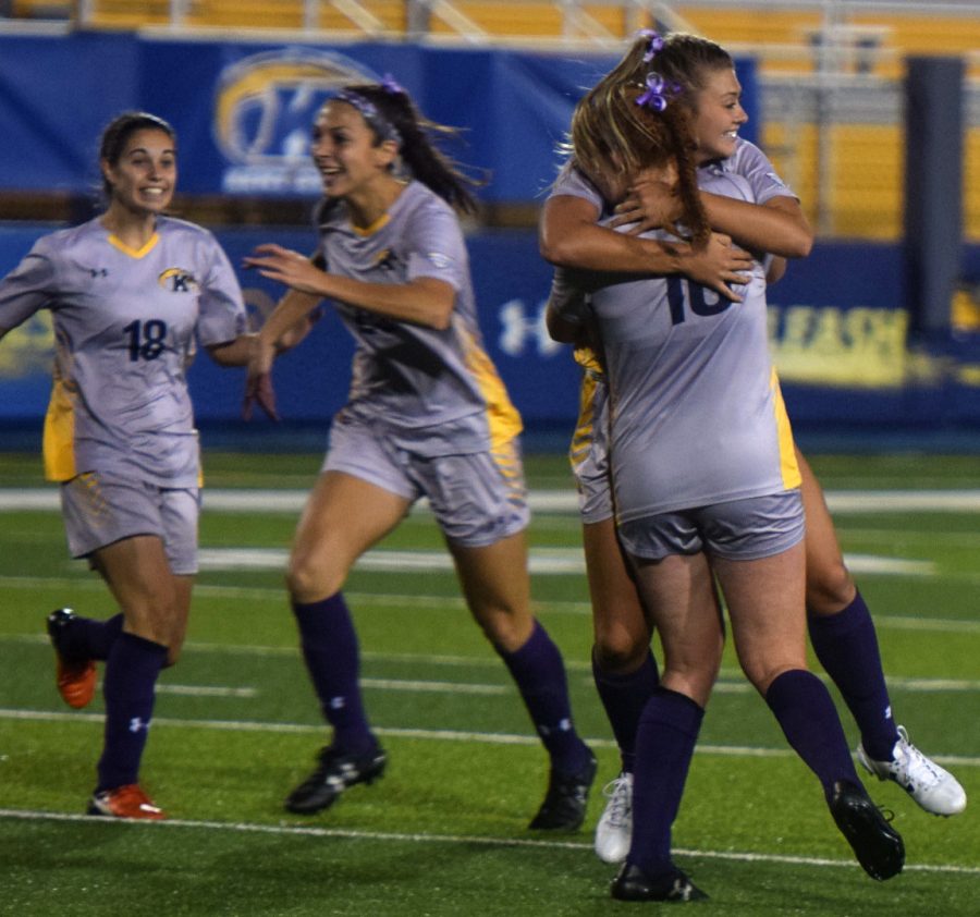 Kent players Cameron Shedenhelm celebrates with teammate Maddie Holmes after Shedenhelm scored the flashes only goal. Kent beat Ball State 1-0.