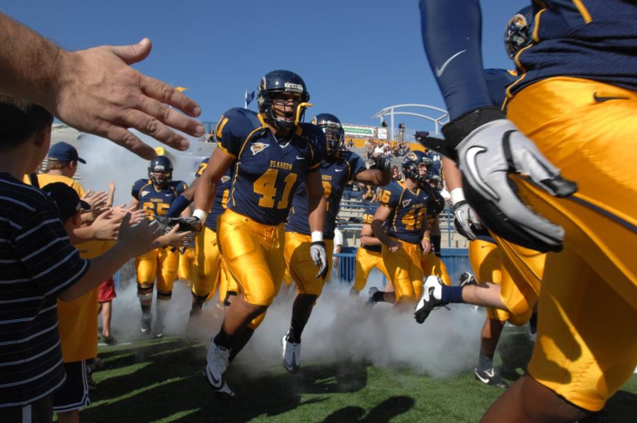 The Kent State Golden Flashes football team takes the field during the 2010 Homecoming Game versus Akron.