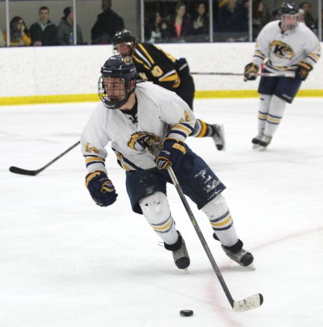 Kent State forward Jon Buttitta, #14, skates the puck out of the zone against Adrian College on Friday, Jan. 22, 2016. The Flashes lost, 5-1.