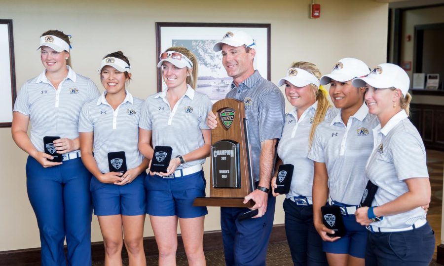 Coach Greg Robertson poses for a portrait with the MAC championship trophy and his team at Silver Lake Country Club on Sunday, April 23, 2017, after Kent State won its 19th consecutive championship. [FILE]