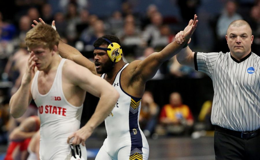 Kent+State+wrestler+Kyle+Conel+celebrates+after+pinning+No.+1+seed+Kollin+Moore+of+Ohio+State+at+the+NCAA+Wrestling+Championships+at+Quicken+Loans+Arena+on+March+16%2C+2018.+Conels+victory+earned+him+a+spot+in+the+Flashes+record+books+as+the+only+unseeded+all-American+in+school+history.