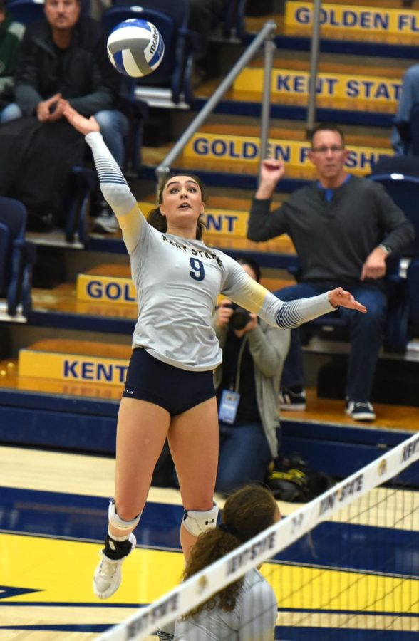 Senior outside hittter Lexi Mantas spikes the ball during the 5th set against Northern Illinois Friday Oct. 19, 2018. Kent State won the match.
