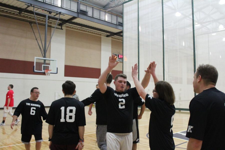 Players on The Knights exchange high-fives at the Unified Sports Basketball League on Tuesday, Nov. 27, 2018.