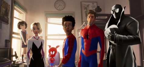 This image shows characters, from left, Peni, voiced by Kimiko Glen, Spider-Gwen, voiced by Hailee Steinfeld, Spider-Ham, voiced by John Mulaney, Miles Morales, voiced by Shameik Moore, Peter Parker, voiced by Jake Johnson, Spider-Man Noir, voiced by Nicolas Cage in a scene from “Spider-Man: Into the Spider-Verse.