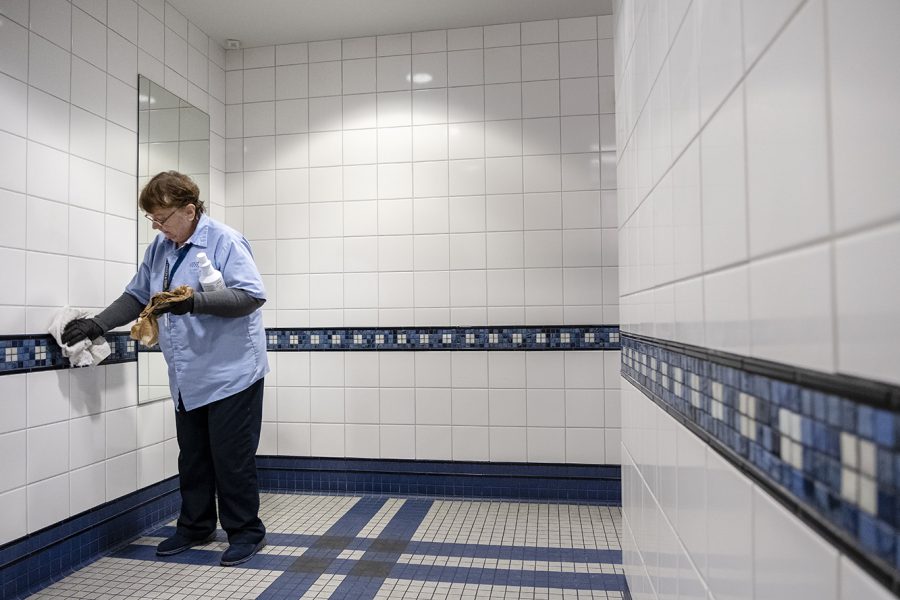 Mary Zieber, 72, a custodian at Kent State, cleans the mens bathroom on the third floor of Franklin Hall on Friday, Nov. 30, 2018. I have my routine down, Zieber said of her work.
