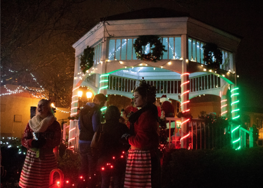 Volunteers stand at the entrance of the gazebo welcoming the first few kids that get to meet Santa on Dec. 1, 2018.