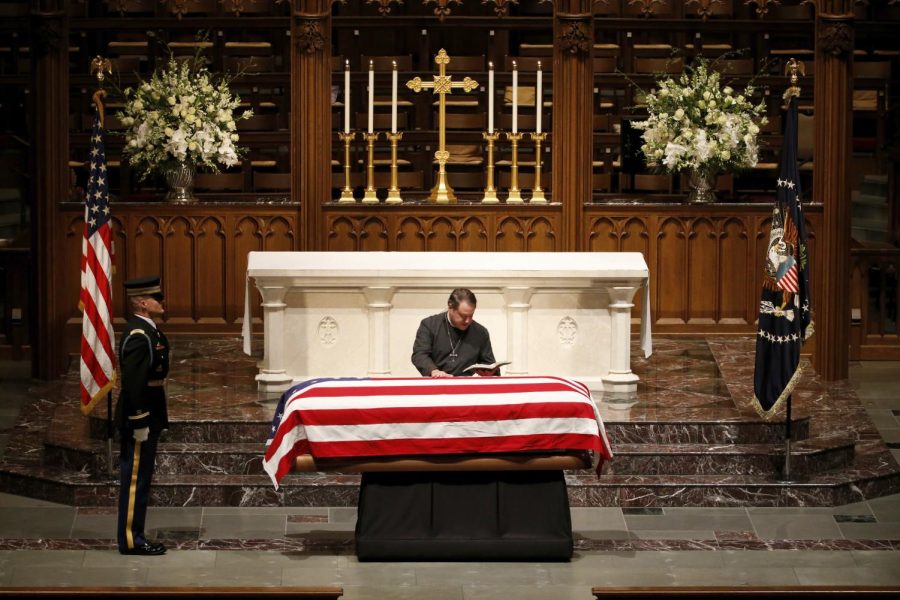 The+Rev.+Russell+J.+Levenson+Jr.+places+his+hand+on+the+flag-draped+casket+of+former+President+George+H.W.+Bush+at+St.+Martins+Episcopal+Church+on+Dec.+5%2C+2018%2C+in+Houston.+%28AP+Photo%2FMark+Humphrey%29