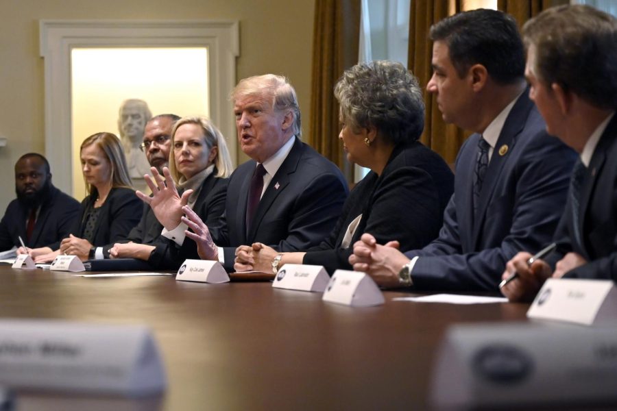 President Donald Trump, center, speaks in the Cabinet Room of the White House in Washington, Wednesday, Jan. 23, 2019, as he hosts a roundtable with conservative leaders to discuss the security and humanitarian crisis at the southern border. 