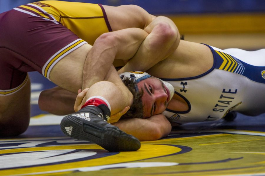 Sophomore Tim Rooney grapples with a Central Michigan wrestler during his match Sunday, Feb. 11, 2018. The Flashes won with a 21-13 upset over the Chippewas, who entered the match ranked second in the Mid-American Conference. 